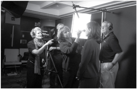 Rosemary Reed (left) supervises makeup application during a recent shoot for Double R Productions
